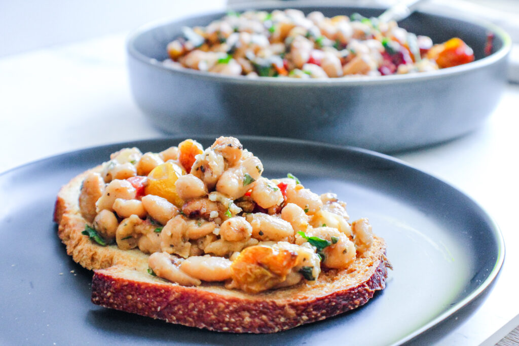 Here's most likely the easiest white bean bruschetta recipe ever and yet one of most delicious. The white beans are creamy and mild and combining them with the flavors in these slow roasted heirloom tomatoes makes this simple bruschetta a winner every time.